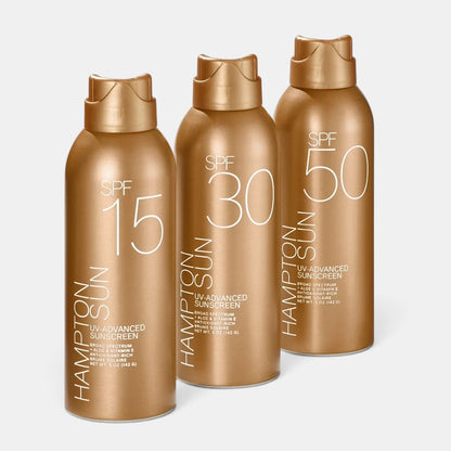 Shop Rescue Spa Hampton Sun SPF 15, 30, and 50 UV-Advanced sunscreen mist bottles in gold packaging.