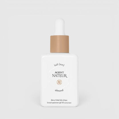 Shop Rescue Spa Agent Nateur Holi (sun) SPF 50 dewy tinted skin drops in almond shade in a white dropper bottle.