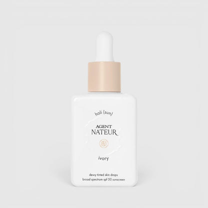 Shop Rescue Spa Holi (sun) SPF 50 dewy tinted skin drops in ivory shade in a white glass bottle with a dropper cap.