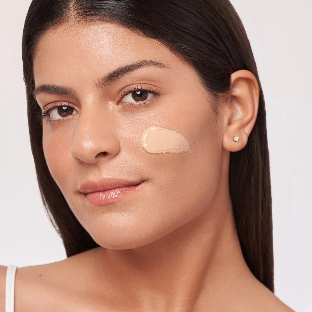 Shop Rescue Spa HydraTint Pro mineral sunscreen applied as a glowing tint on a woman&