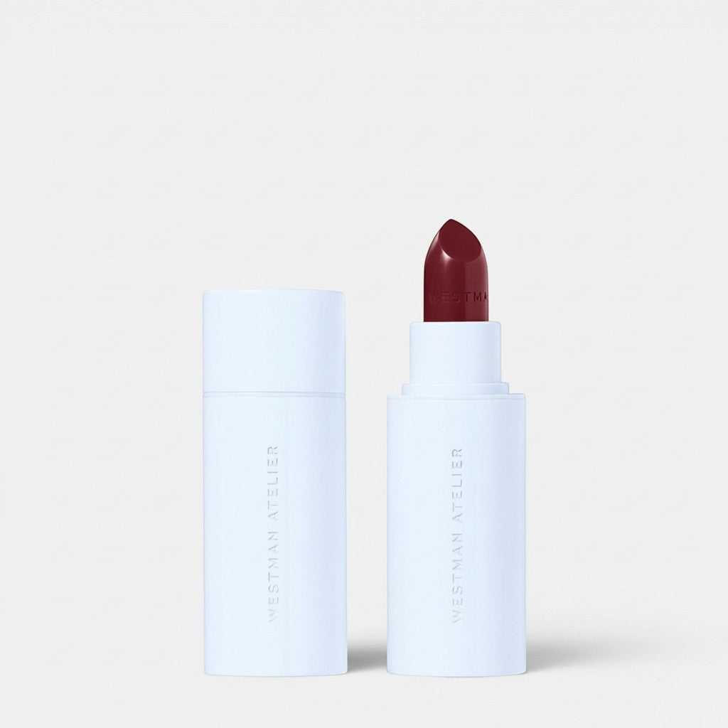 Shop Rescue Spa Hydrobalm Tinted Lipstick in a deep berry shade with a white minimalist tube and cap