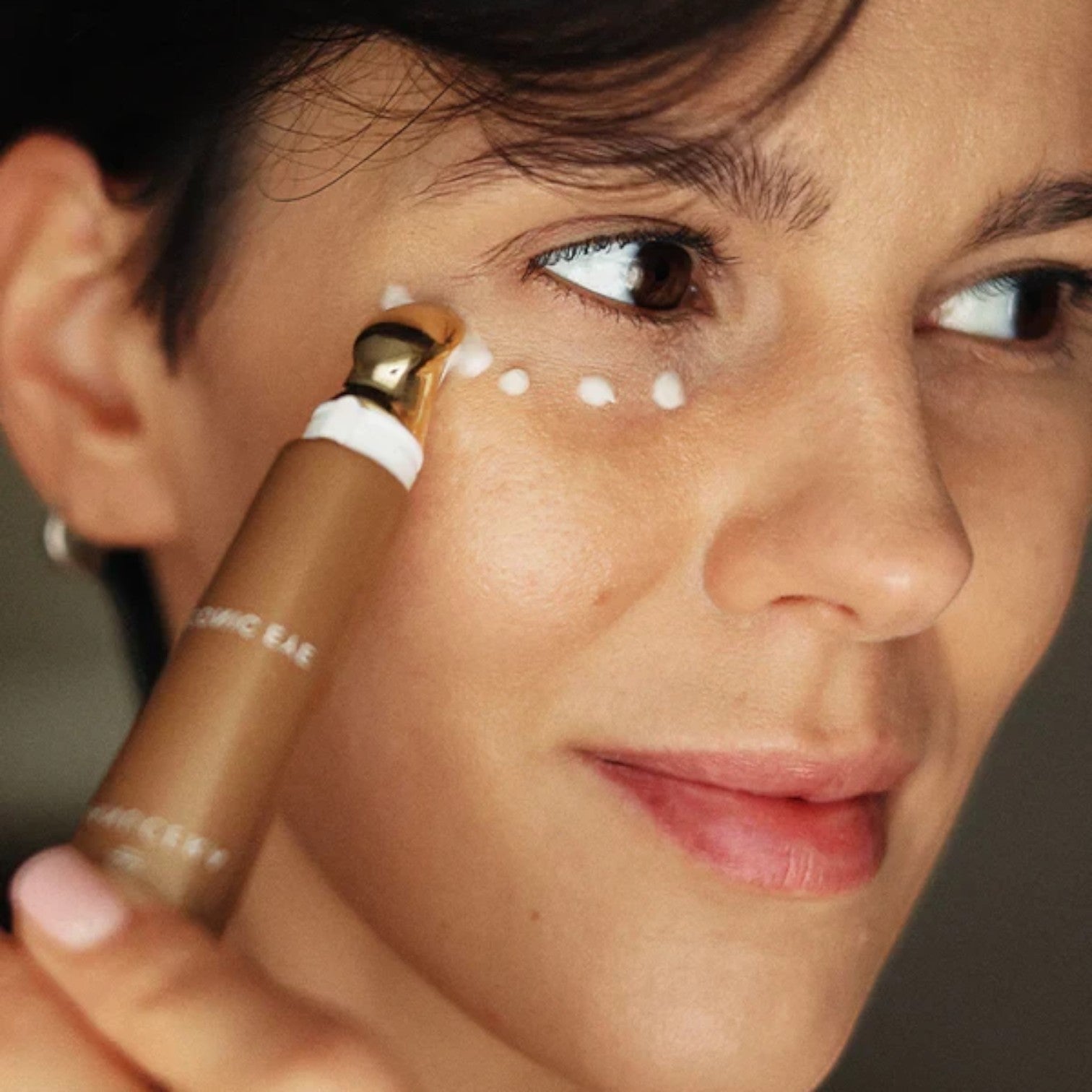 Shop Rescue Spa Danucera Iconic Eye cream being applied under the eye with a cooling gold applicator tool