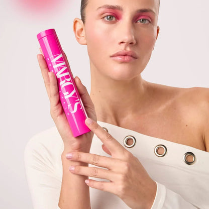 Shop Rescue Spa iMask Botolift coconut fiber sheet mask in a bright pink tube held by a model with pink eyeshadow
