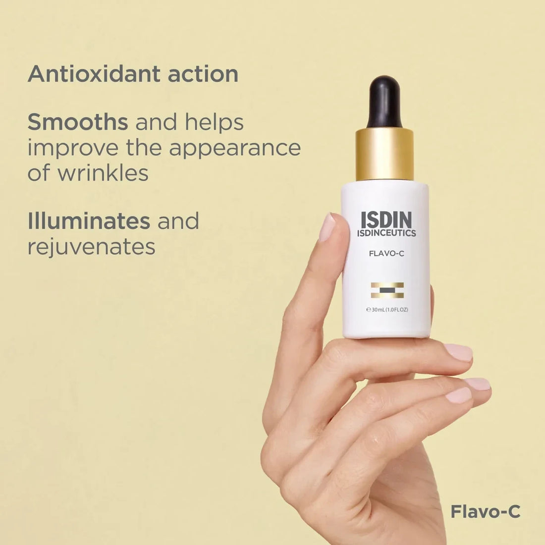 Shop Rescue Spa ISDIN Flavo-C antioxidant serum bottle held in hand against a soft yellow background
