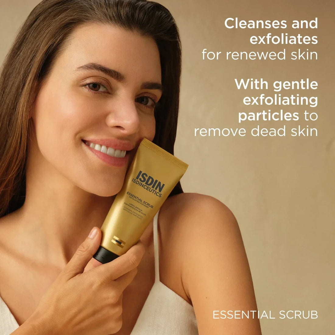Shop Rescue Spa Isdinceutics Essential Scrub held by a smiling woman, featuring a gold tube for facial exfoliation.