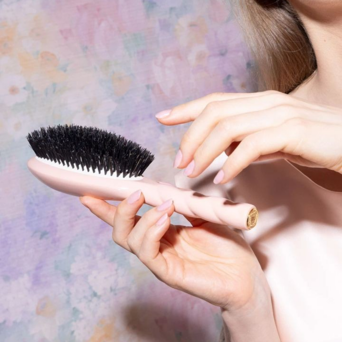 Shop Rescue Spa N.01 large ivory boar bristle hair brush held by a woman with a soft pink manicure