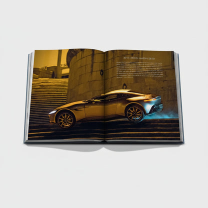 James Bond Cars book featuring a 2015 Aston Martin DB10 on a staircase with blue exhaust fumes.