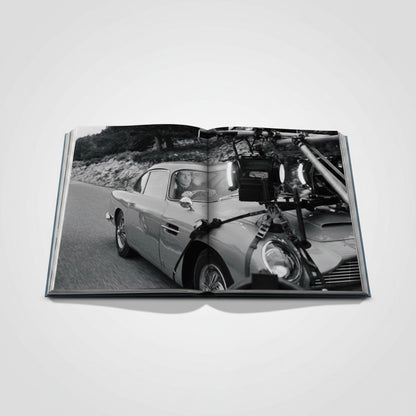 Shop Rescue Spa James Bond Cars book features an Aston Martin DB5 on a scenic road, with film equipment attached.