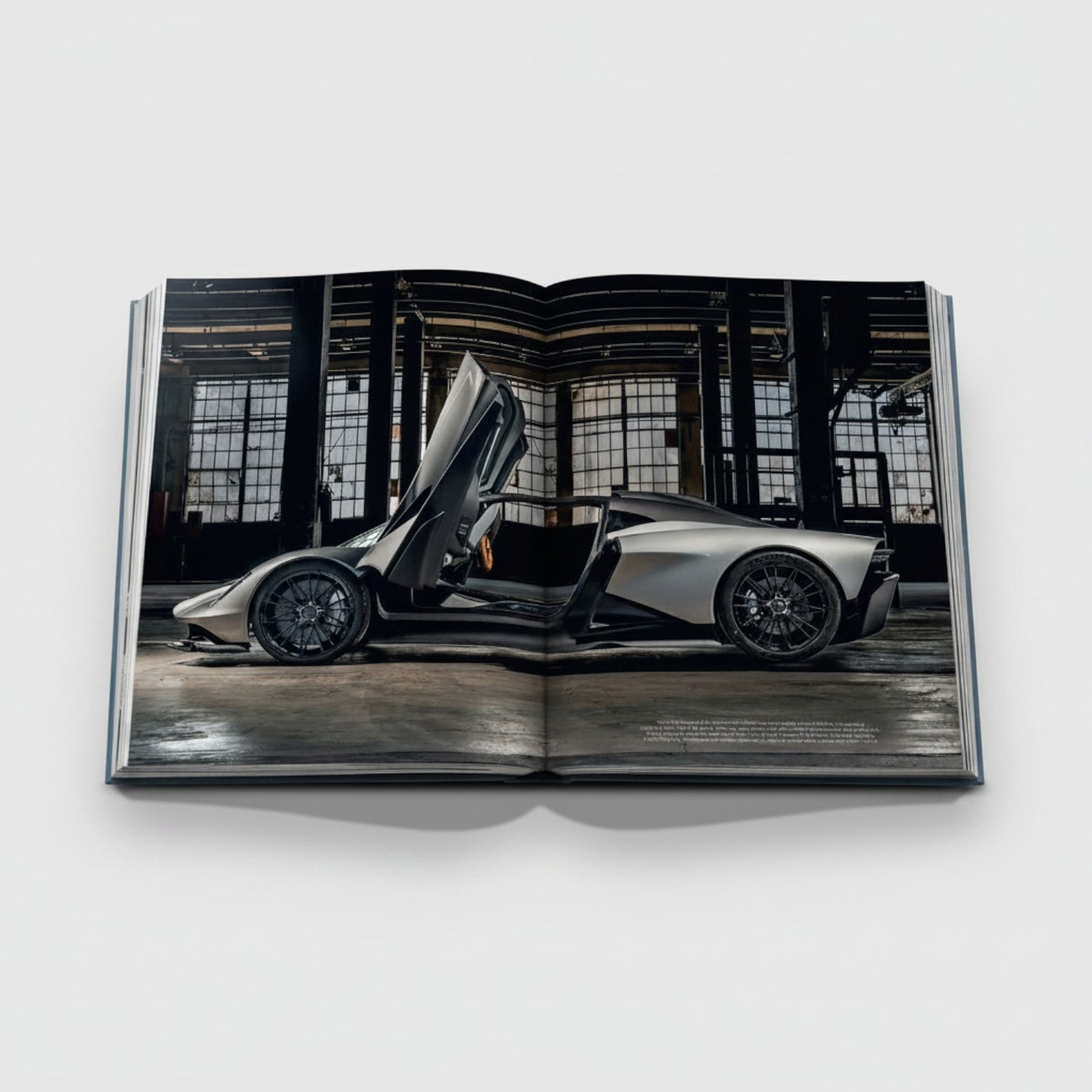 Shop Rescue Spa James Bond Cars book featuring a silver Aston Martin with doors open in a warehouse setting.