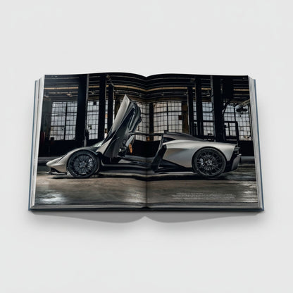 Shop Rescue Spa James Bond Cars book featuring a silver Aston Martin with doors open in a warehouse setting.