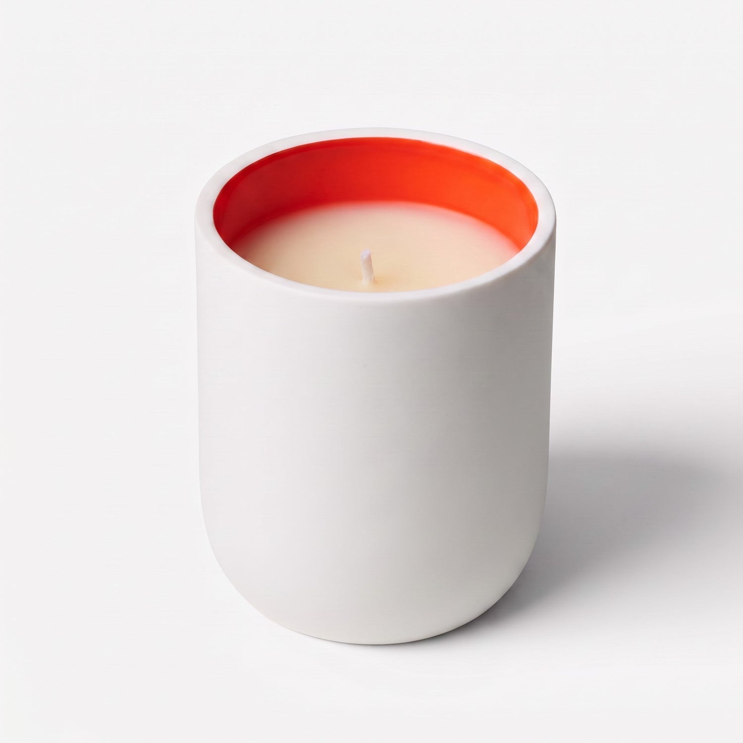 Shop Rescue Spa Jurassic Flower magnolia scented candle in a white matte porcelain vessel with a vibrant orange interior