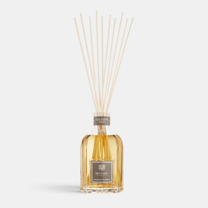 Shop Rescue Spa Leather Oud room diffuser in a glass bottle with reed sticks, featuring a warm amber fragrance oil.