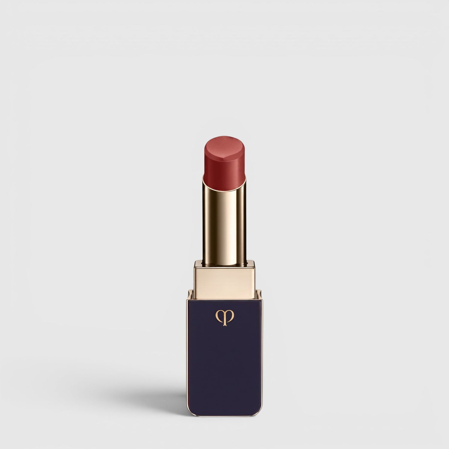 Shop Rescue Spa Lipstick Shine in a deep rose shade with a luminous dewy finish in a sleek navy and gold tube