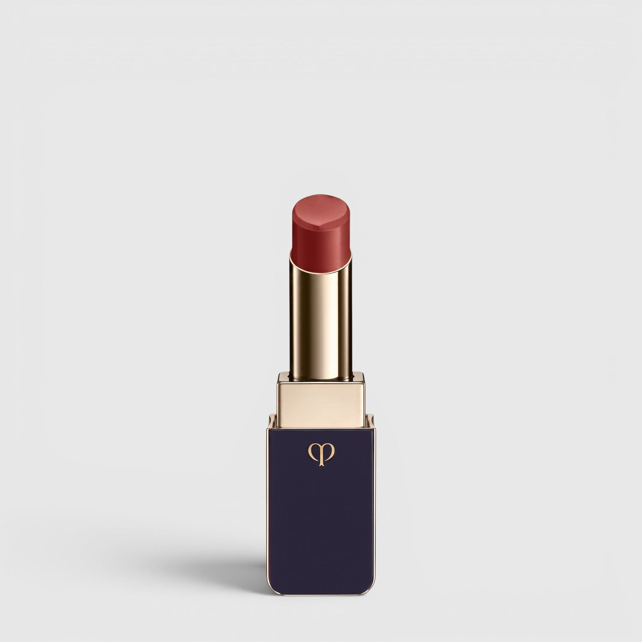 Shop Rescue Spa Lipstick Shine in a deep rose shade with a luminous dewy finish in a sleek navy and gold tube
