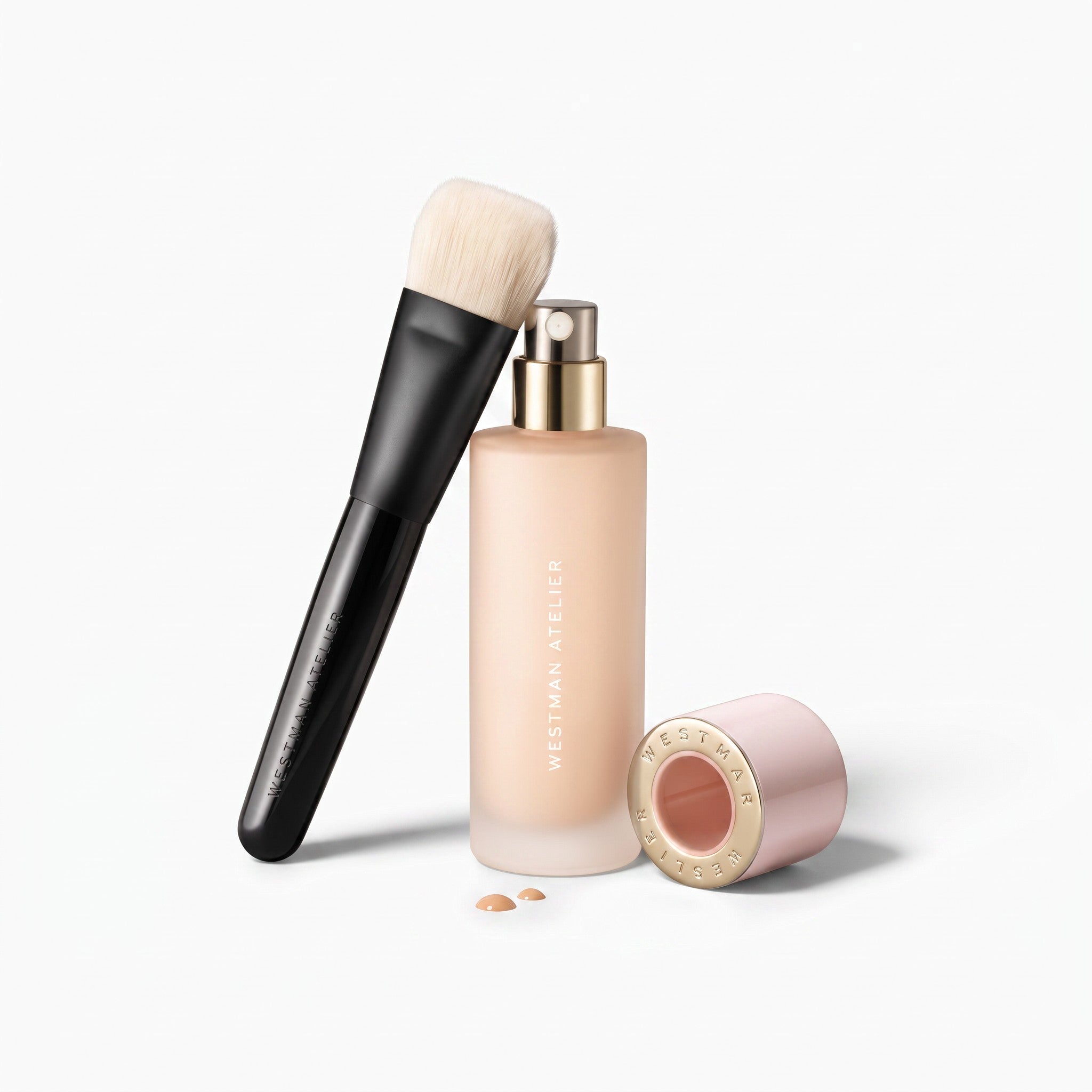 Shop Rescue Spa artisan liquid foundation brush with 5-dimensional head next to a bottle of Westman Atelier foundation