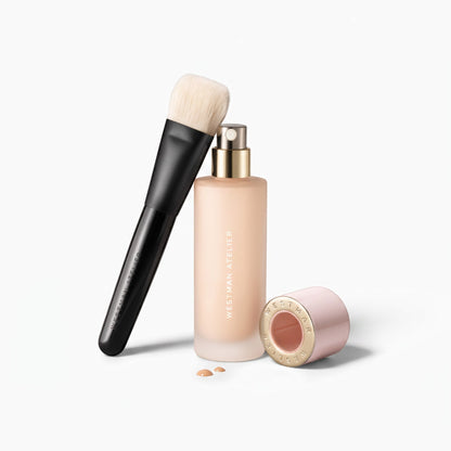 Shop Rescue Spa artisan liquid foundation brush with 5-dimensional head next to a bottle of Westman Atelier foundation