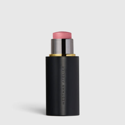 Shop Rescue Spa Lit Up Highlight Stick in a sleek black twist-up tube with a radiant pink-toned gel highlighter.