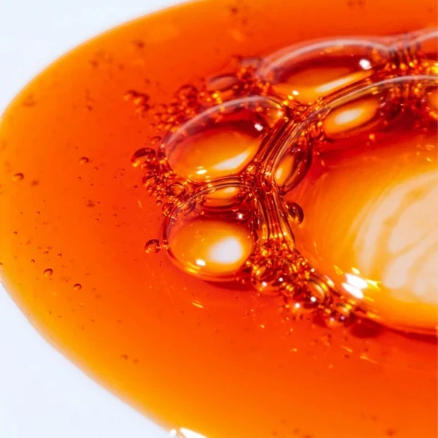 Close-up texture of Shop Rescue Spa Danucera Master Mask showing a rich, amber-colored gel with small air bubbles.