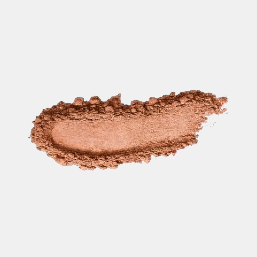 Shop Rescue Spa Beauty Butter Powder Bronzer swatch showing a smooth matte warm brown pressed powder texture.