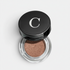 Shop Rescue Spa Mermaid Eye Matte eyeshadow in a bronze shade with a velvet finish in a glass pot with black lid.