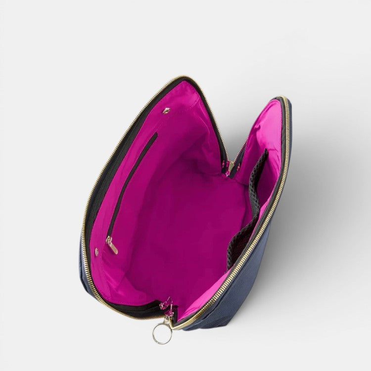 Shop Rescue Spa navy leather makeup bag with bright pink interior, zip-out liner, and internal pockets.