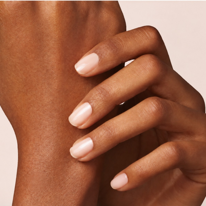 Shop Rescue Spa natural nail polish in a soft glossy nude shade applied on a model&