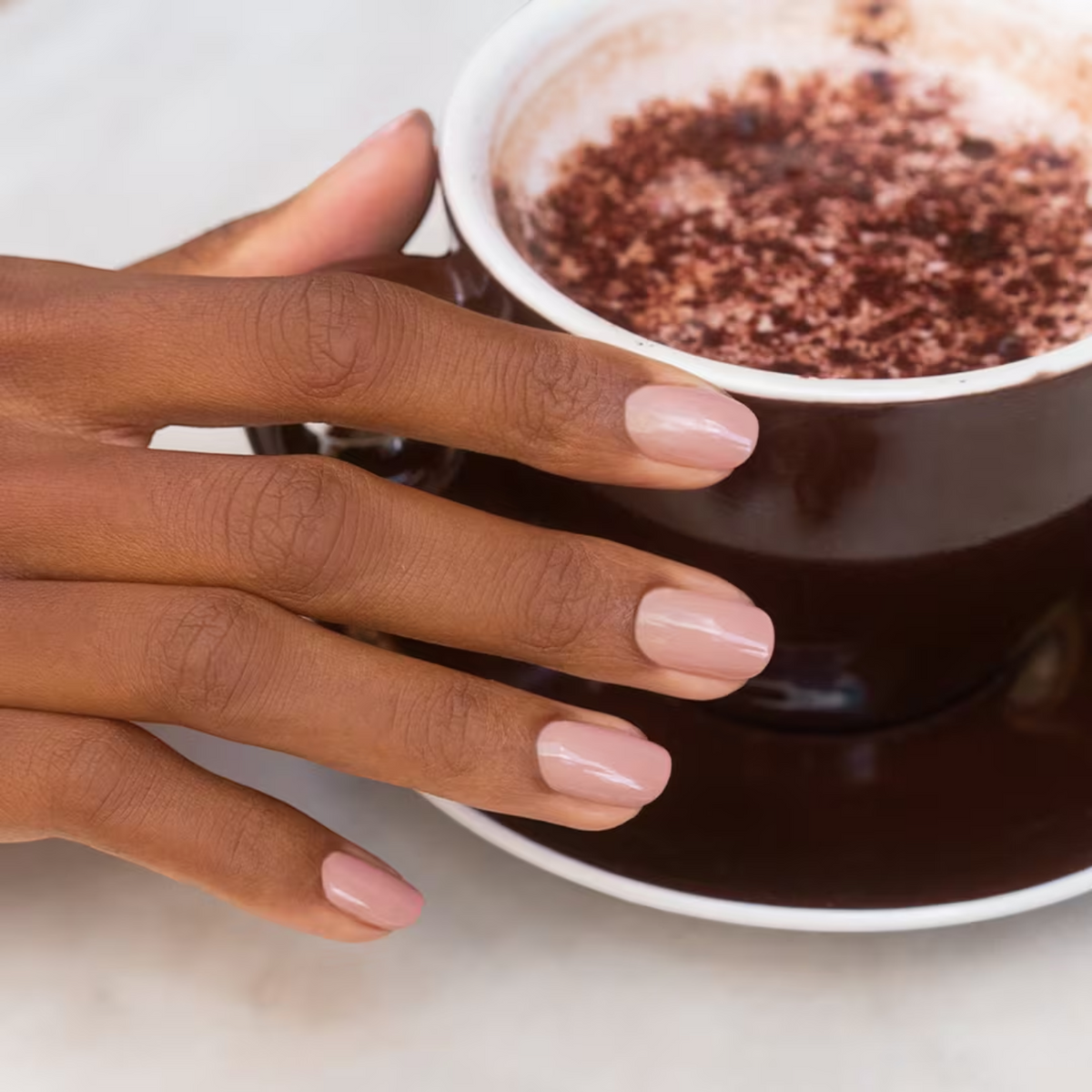Shop Rescue Spa natural nail polish in a soft nude shade on a model&