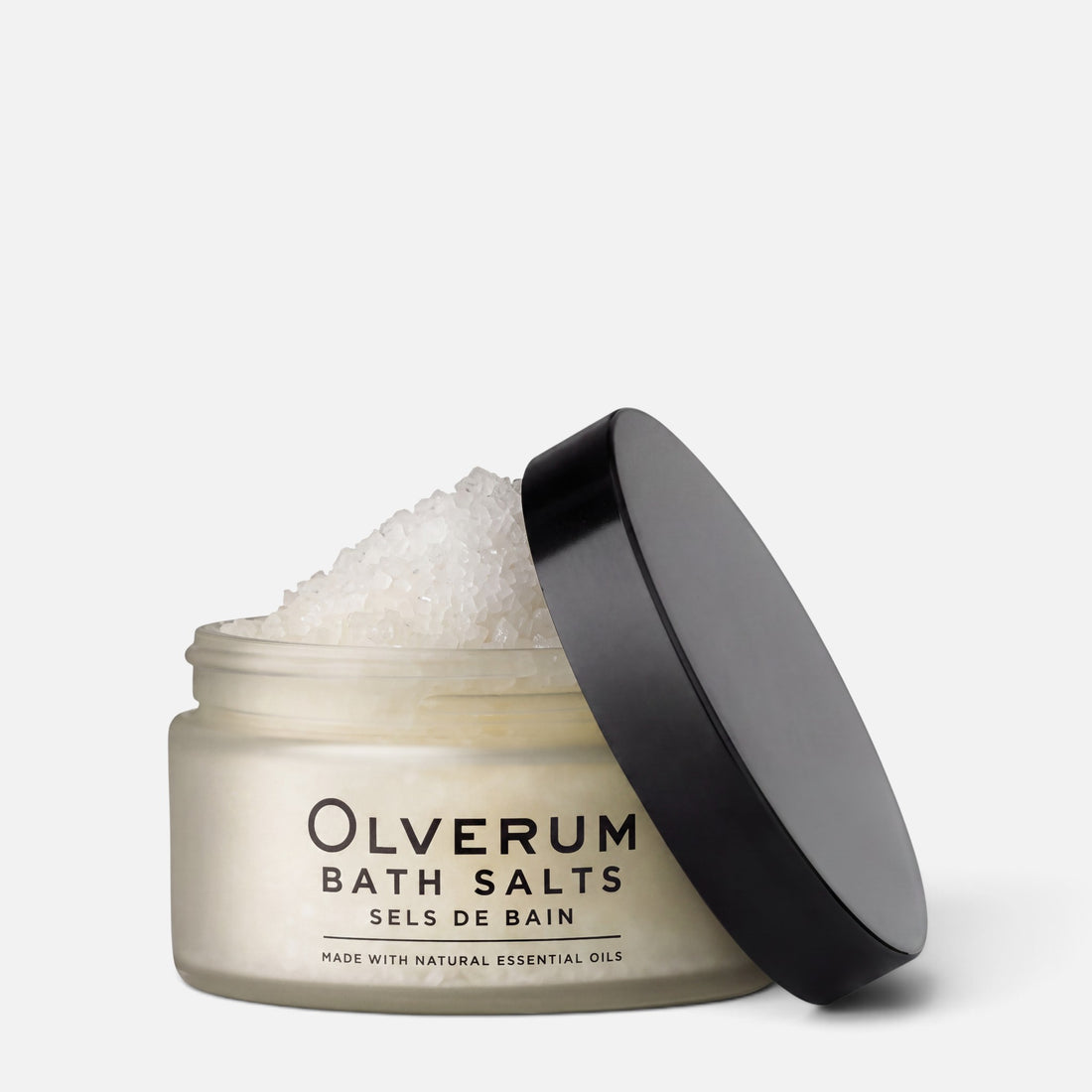 Shop Rescue Spa Olverum mineral-rich bath salts in a frosted glass jar with a black lid for a relaxing bath ritual.