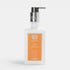 Shop Rescue Spa Orange Blossom Lilac & Jasmine body moisturizer in a clear pump bottle with an orange label.