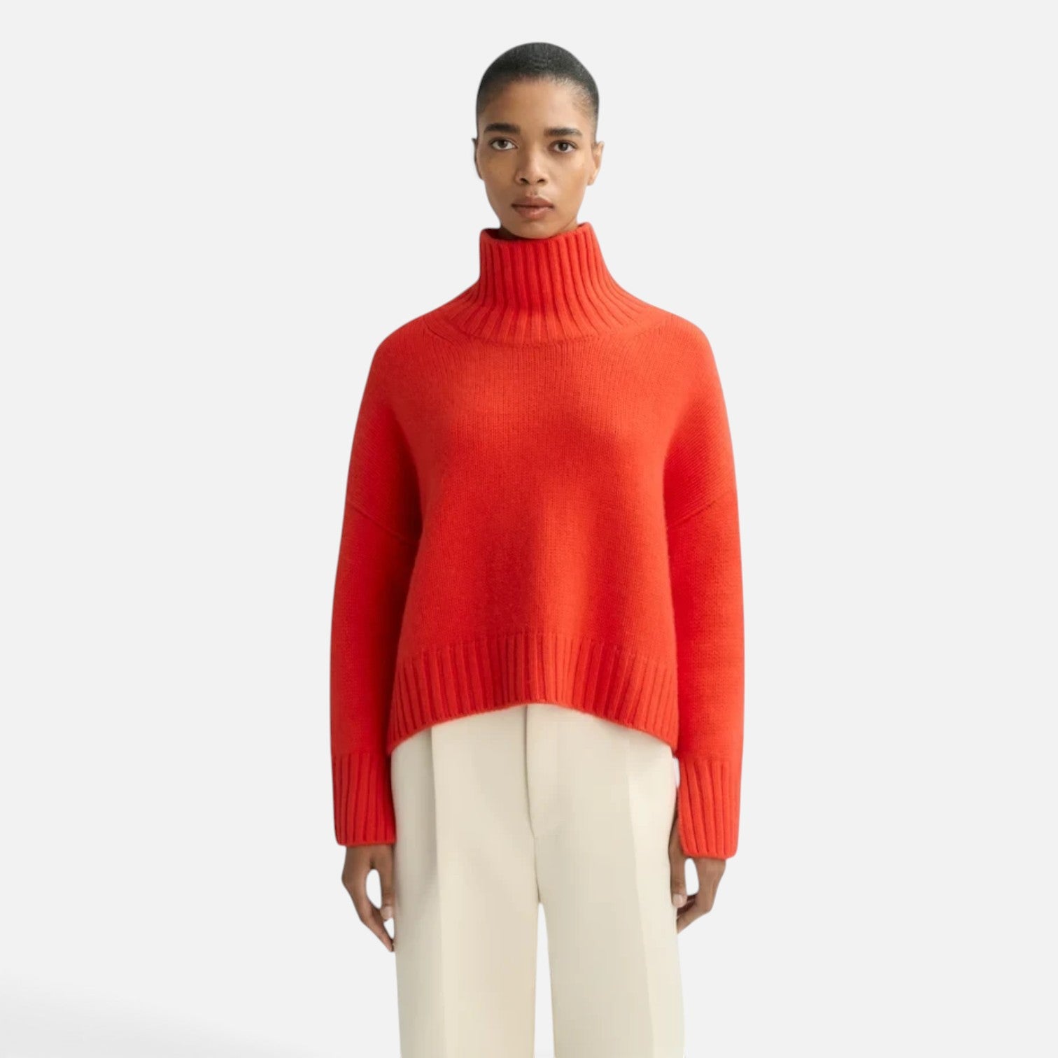 Shop Rescue Spa Girlfriend turtleneck sweater in bright orange chunky cashmere with sleeve slits on a model