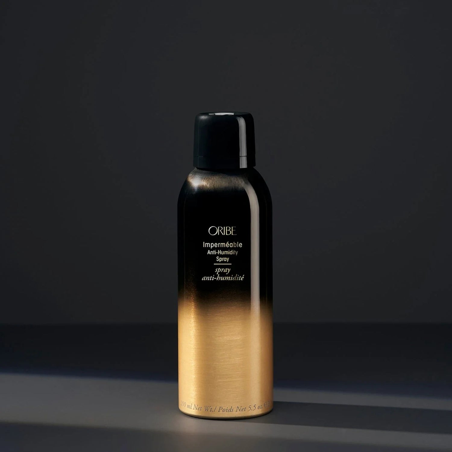Shop Rescue Spa Oribe Impermeable Anti-Humidity Spray in a black and gold aerosol bottle for frizz-free hair styling.