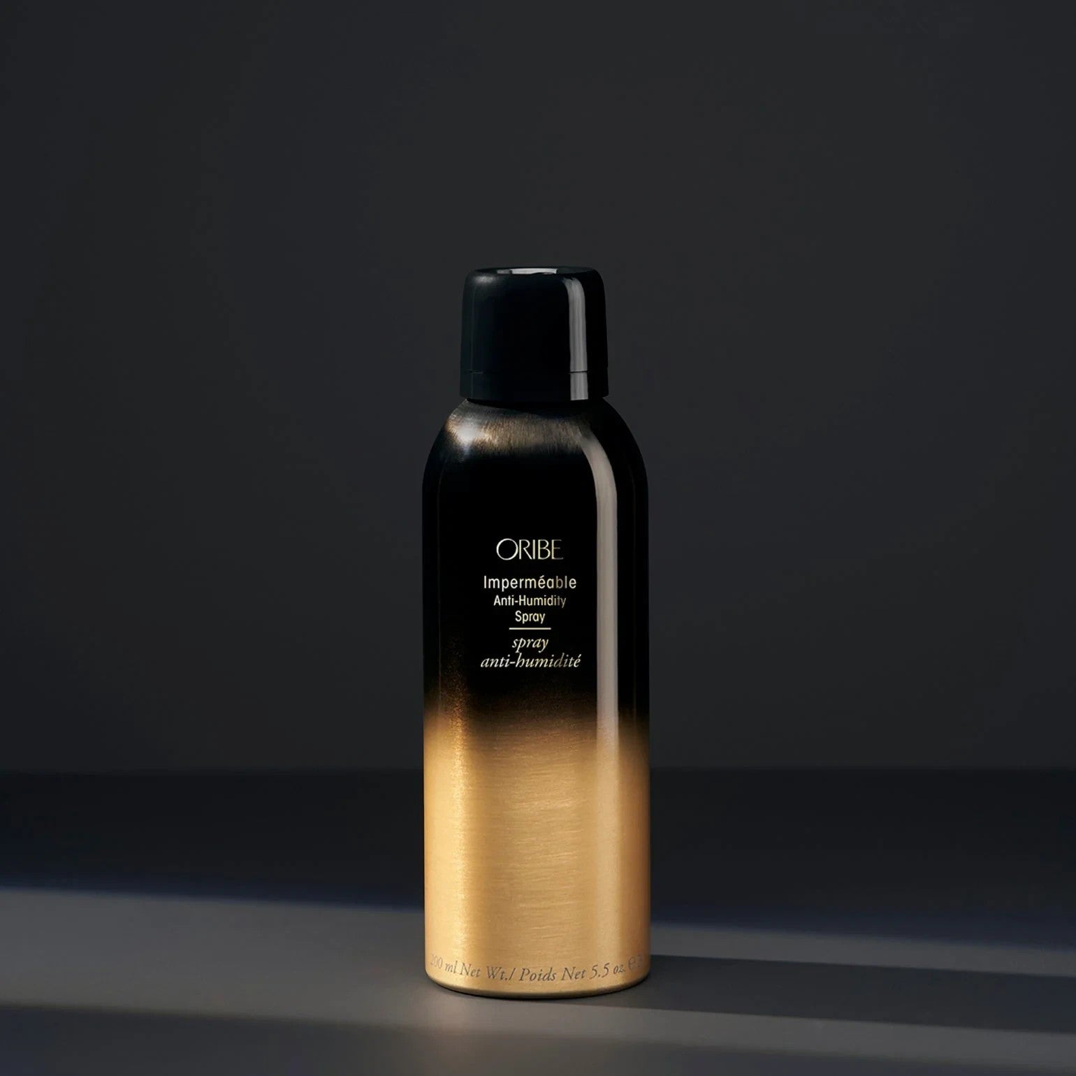 Shop Rescue Spa Oribe Impermeable Anti-Humidity Spray in a black and gold aerosol bottle for frizz-free hair styling.