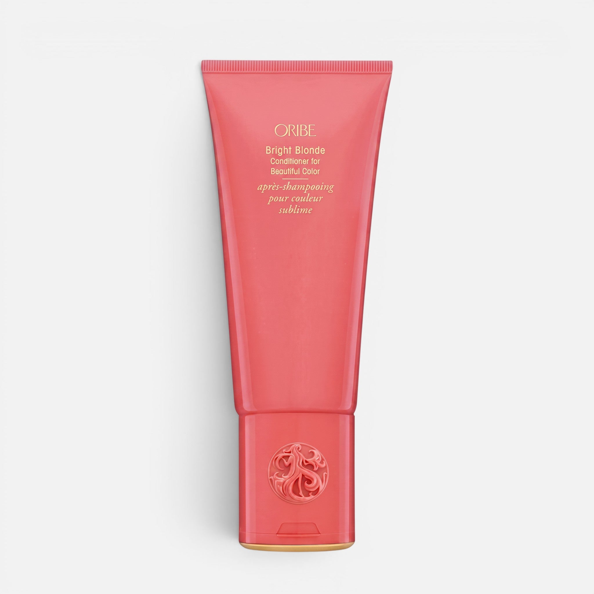 Shop Rescue Spa Oribe Bright Blonde Conditioner in a coral-colored squeeze tube for toning blonde and silver hair.