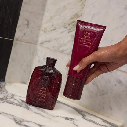 Shop Rescue Spa Oribe Conditioner and Shampoo for Beautiful Color in deep red bottles with water droplets