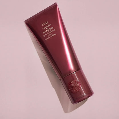 Shop Rescue Spa Oribe Conditioner for Beautiful Color in a deep burgundy tube for color-treated hair.