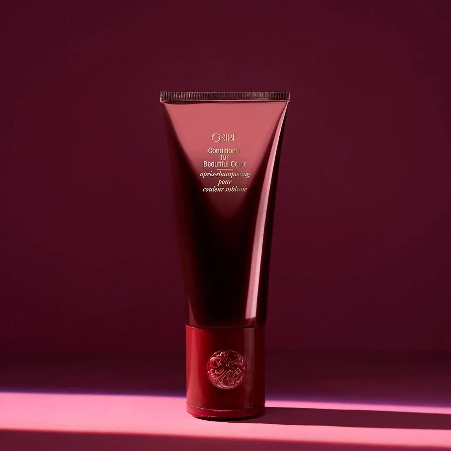 Shop Rescue Spa Oribe Conditioner for Beautiful Color in a deep red tube for color-treated hair.
