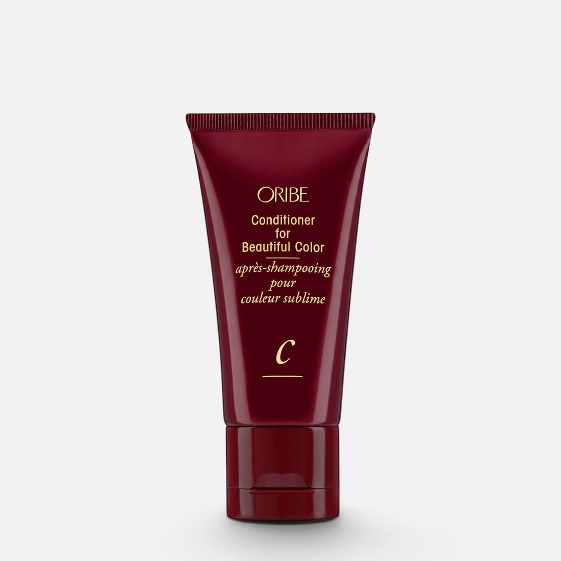 Shop Rescue Spa Oribe Conditioner for Beautiful Color in a deep red squeeze tube for color-treated hair