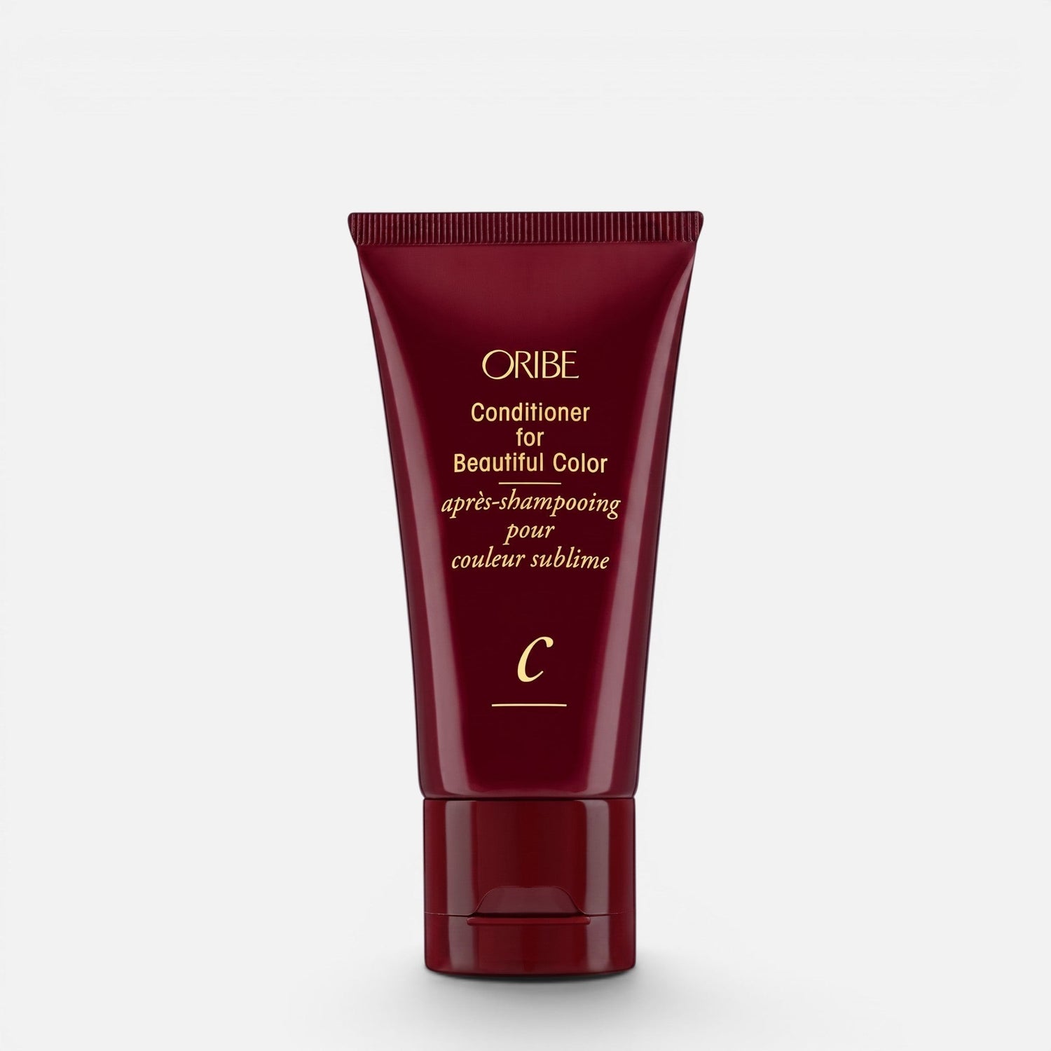 Shop Rescue Spa Oribe Conditioner for Beautiful Color in a deep red squeeze tube for color-treated hair