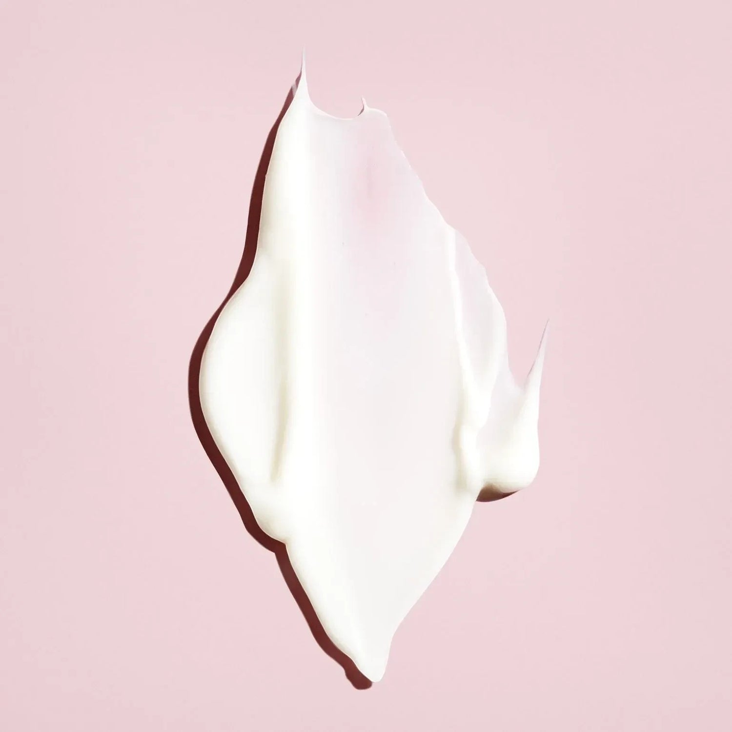 Shop Rescue Spa Oribe Conditioner for Beautiful Color cream texture swatch on a soft pink background