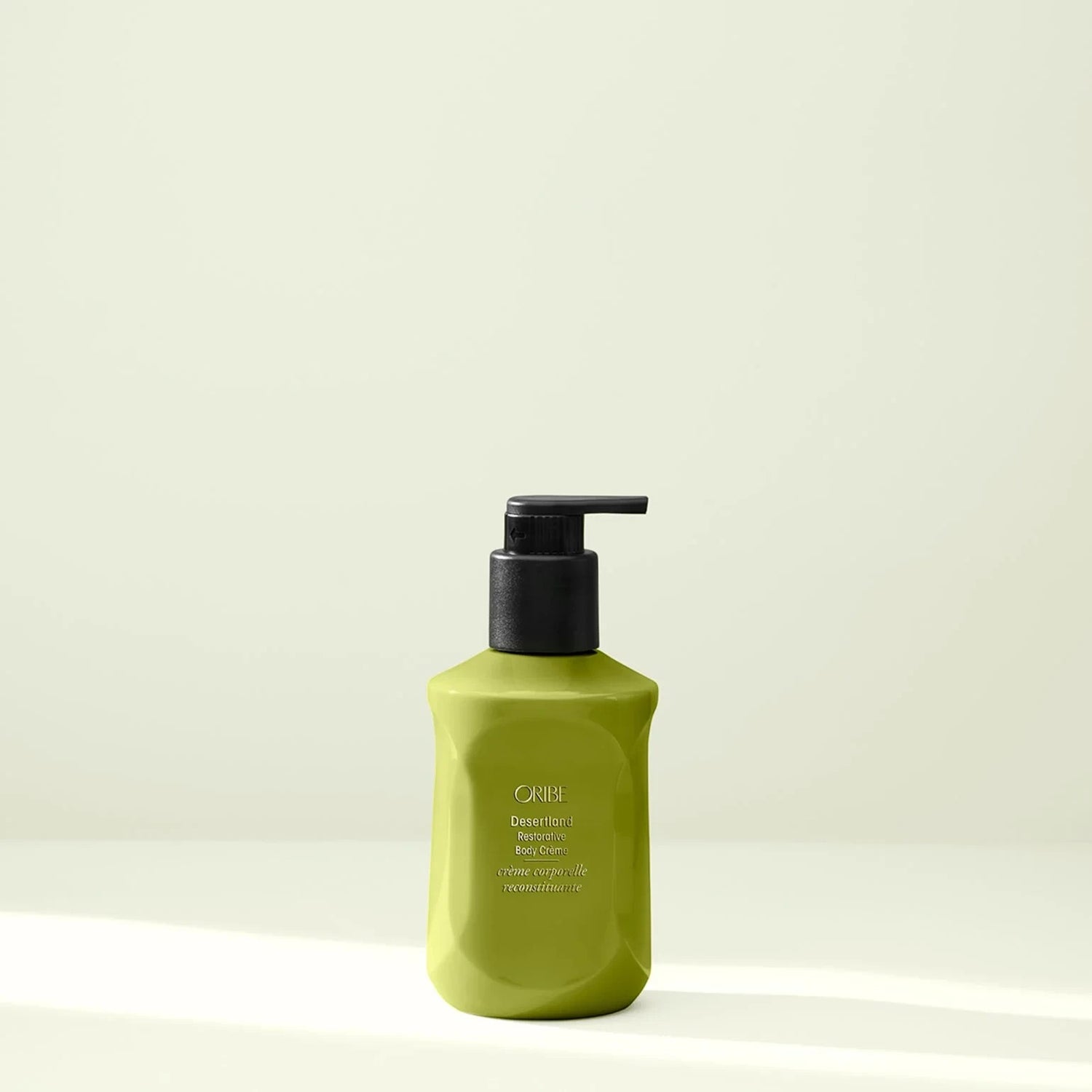 Shop Rescue Spa Oribe Desertland Restorative Body Creme 300ml, a lime green pump bottle with black pump.