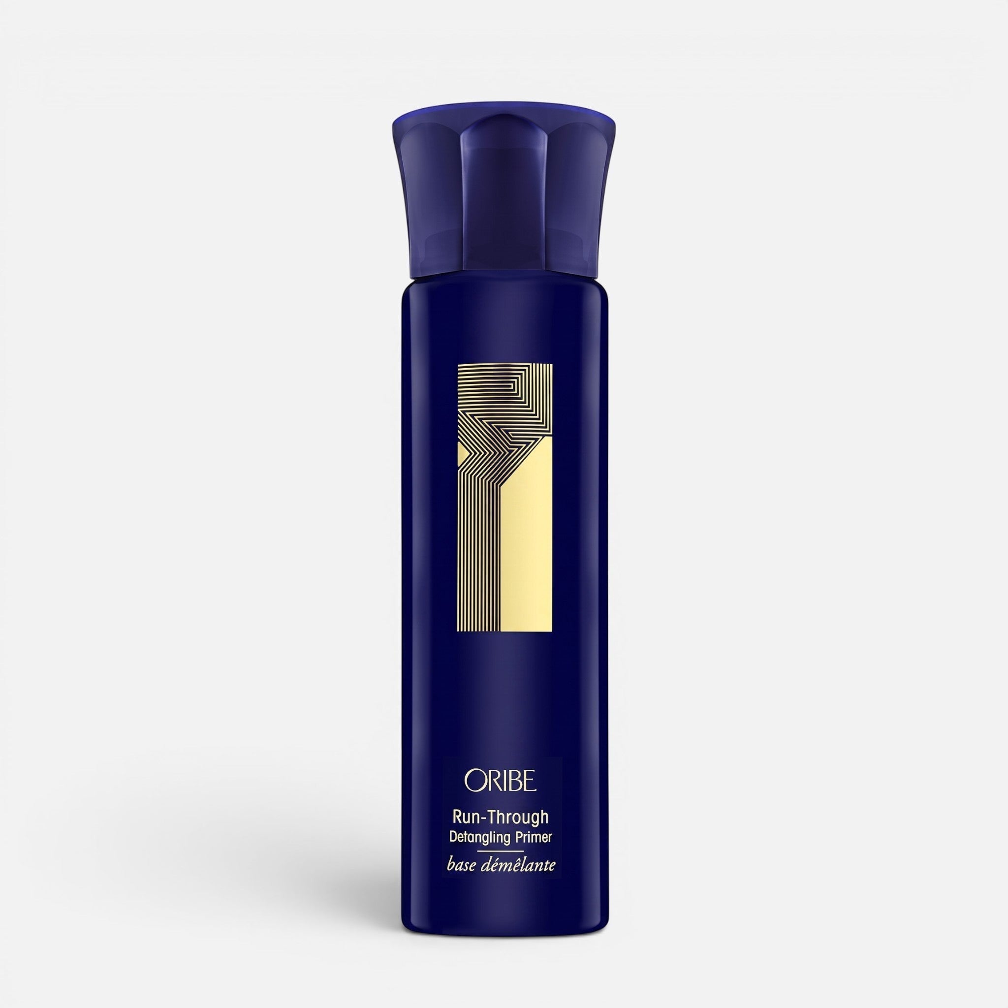 Shop Rescue Spa Oribe Run-Through Detangling Primer in a dark blue spray bottle for heat protection and detangling.