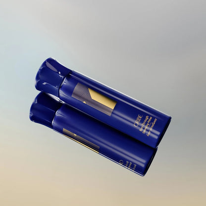 Shop Rescue Spa Oribe Run-Through Detangling Primer in a blue bottle with gold logo on a reflective surface.