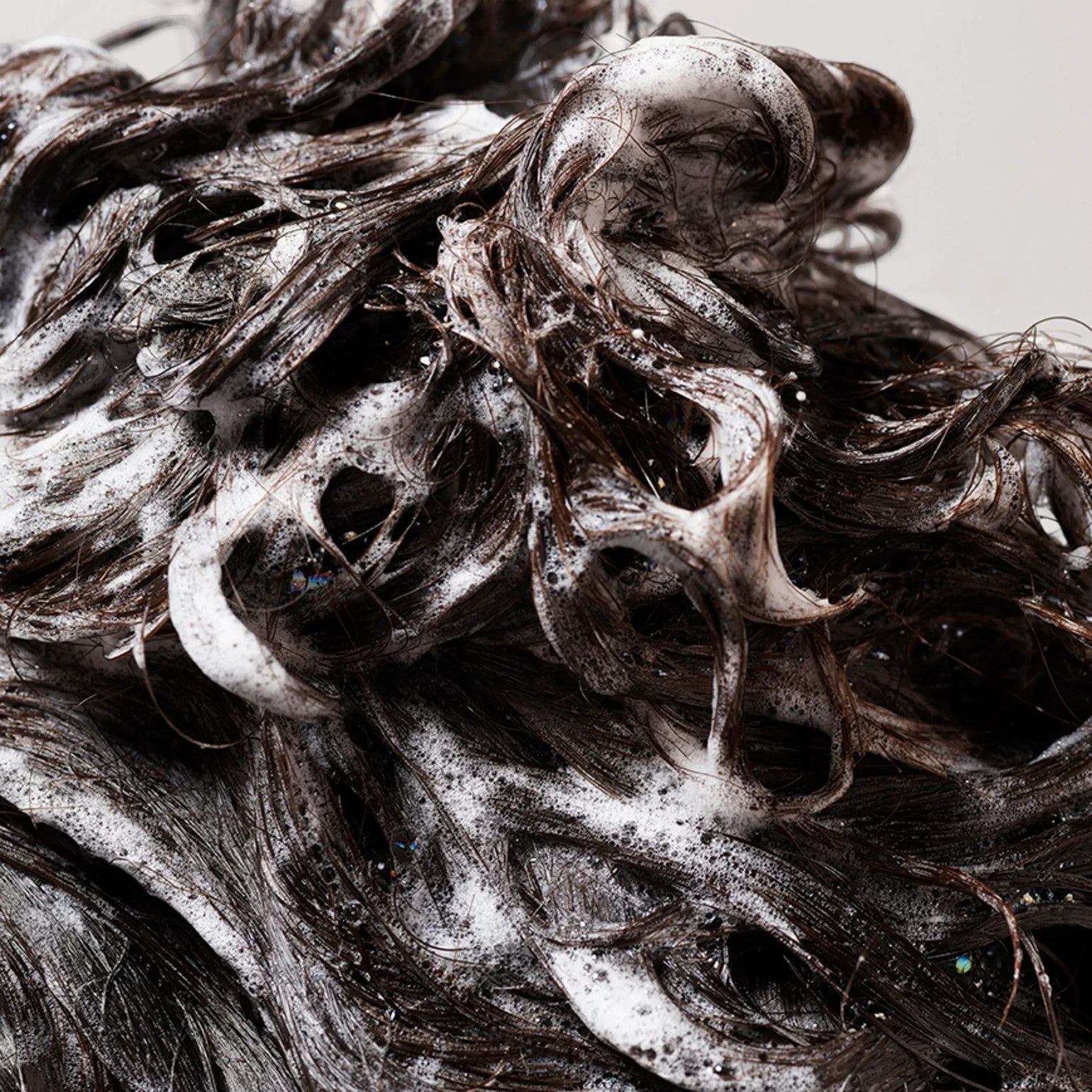 Shop Rescue Spa Oribe Gold Lust Repair and Restore Shampoo lathering in dark brown hair for a deep cleanse