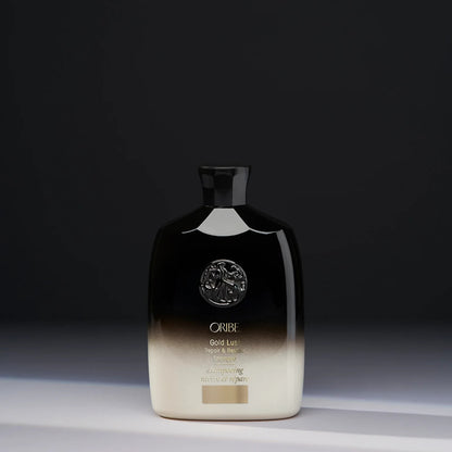 Shop Rescue Spa Oribe Gold Lust Repair and Restore Shampoo in a black and cream bottle against a dark background.