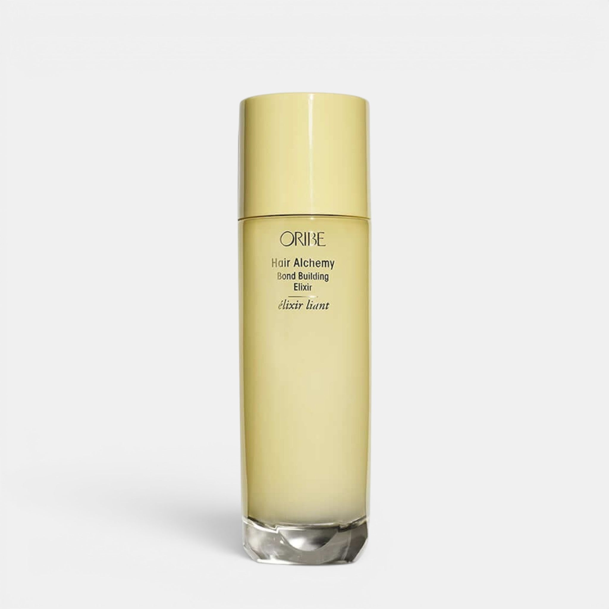 Shop Rescue Spa Oribe Hair Alchemy Bond Building Elixir in a tall, pale yellow cylindrical bottle.