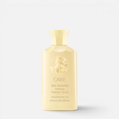 Shop Rescue Spa Oribe Hair Alchemy Fortifying Treatment Serum in a pale yellow bottle with embossed logo detail.