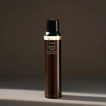 Shop Rescue Spa Oribe Grandiose Hair Plumping Mousse in a sleek brown and gold canister for voluminous hair styling.