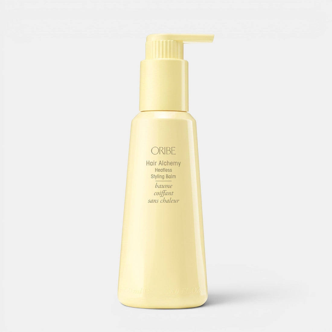 Shop Rescue Spa Oribe Hair Alchemy Heatless Styling Balm in a pale yellow pump bottle for defining air-dried waves.
