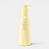 Shop Rescue Spa Oribe Hair Alchemy Heatless Styling Balm in a pale yellow pump bottle for defining air-dried waves.