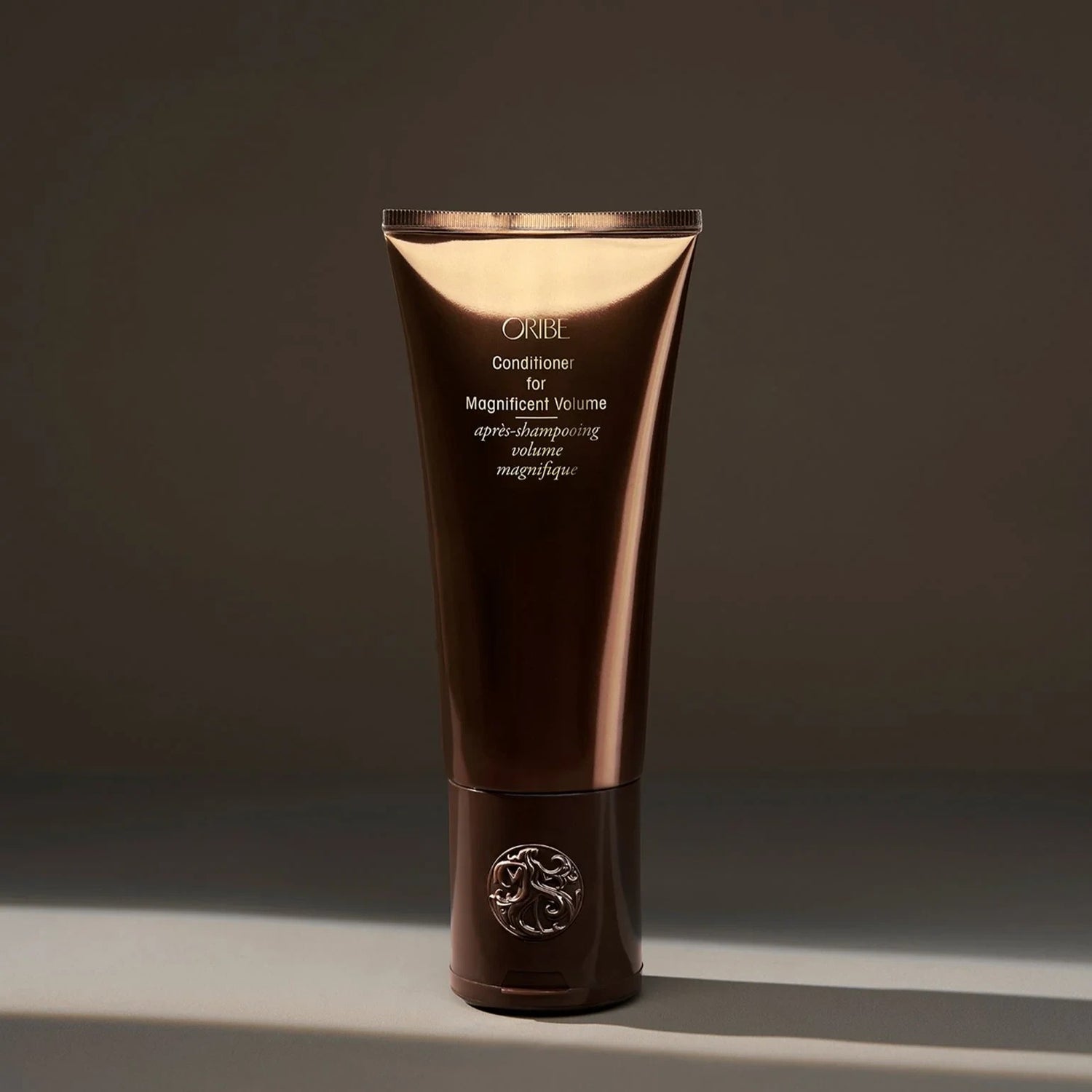 Shop Rescue Spa Oribe Conditioner for Magnificent Volume, a volumizing conditioner for fine to medium hair in a brown tube.